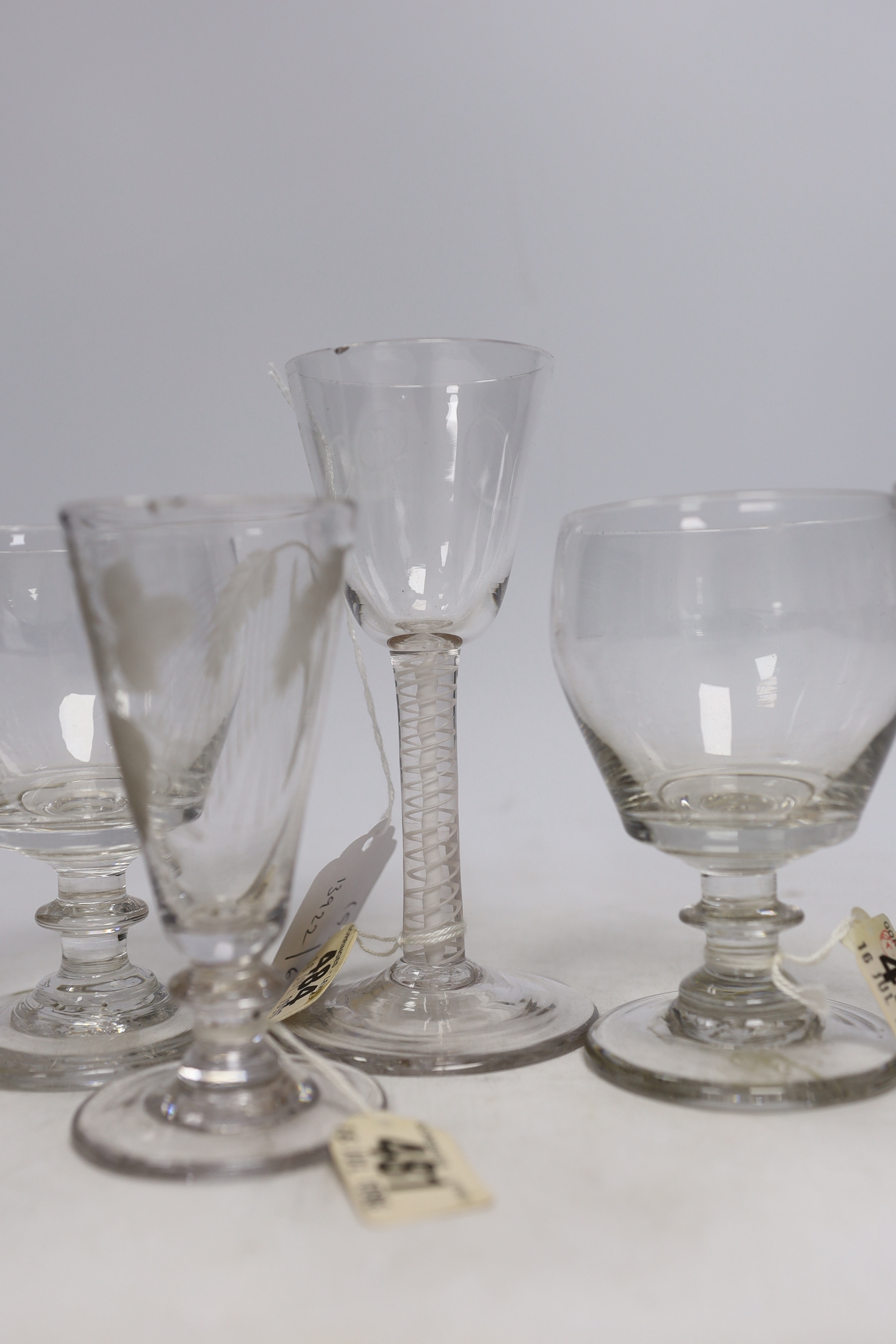 Two late 18th century DSOT Wine glasses, two dwarf ale glasses with engraved hops and barley, and knopped stems, two early 19th century drummers with knopped stems and rough pontils, tallest 16cm (6)